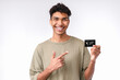 © InsideCreativeHouse - Happy young african-american man pointing at credit card isolated over white