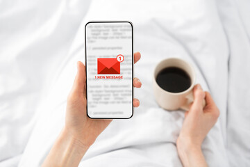 Poster - Woman Holding Phone With E-Mail Message Lying In Bed Indoor