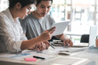 © amnaj - Young Asian businessman have a meeting analysis using a tablet at the office.