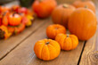 © Martin Barraud/Caia Image - Close up vibrant orange pumpkin display on wood table