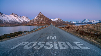 Wall Mural - im possible text quote printed on asphalt road towards the mountains during blue hour.