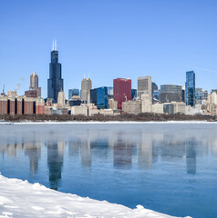 Wall Mural - Big city skyline along frozen lakeshore in winter