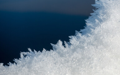 snowflakes in the ice snow on blue background