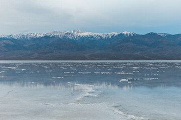 Canvas Print - Blue hour with snow capped Telescope Peak reflecting in wet salt field of Death Valley