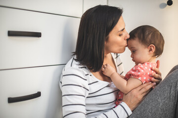 Wall Mural - Happy loving family. mother and child girl playing, kissing and hugging