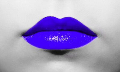 Wall Mural - Female lips close-up with deep blue lipstick bright juicy color on a background of black and white face.