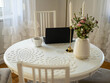 © Marcin - Home office. Laptop standing on the white round table. Beautifull bouquet of flowers and candles.