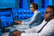 © Acronym - Team of brokers is working in office using workstation and analysis technology. Workplace of professional traders. Global financial markets, business, currency exchange and banking concepts.
