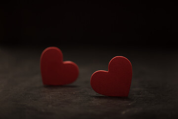 Close-up on two red hearts on a dark background. Valentine's concept. Symbol of love.