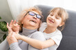© Angelov - Teenage Granddaughter Visiting Grandmother At Home