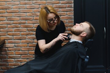 Client during beard shaving in barber shop