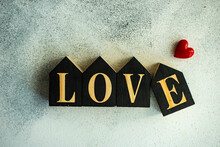 Word LOVE Written With Wooden Blocks And A Heart Shape Decoration