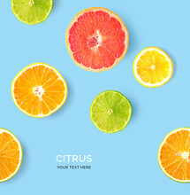 Creative Pattern Made Of Lemon, Lime, Orange And Grapefruit. Flat Lay. Food Concept. Lemon, Lime, Orange And Grapefruit On Blue Background.