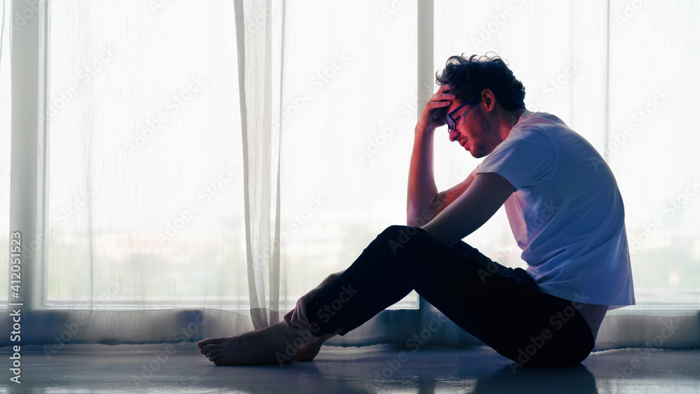 man sitting alone at home looking sorrow with desperate and depressed - obrazy, fototapety, plakaty 