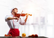 © adam121 - Young male chef with violin standing
