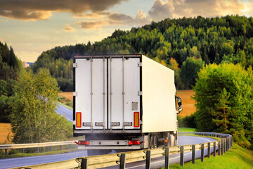 Wall Mural - White Semi Trailer Transporter on Road at Dusk