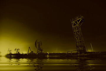 Wall Mural - Oil pumping machinery in operation, crude oil extraction scene in the night, North China