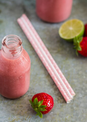 Wall Mural - Strawberry smoothie in bottle on metal background