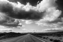 Road Passing Through Landscape Against Cloudy Sky