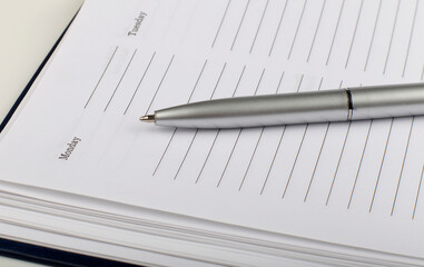 Poster - Close-up of diary and pen on the wooden background