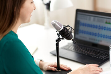 Sticker - technology, mass media and people concept - close up of woman with microphone and laptop computer talking and recording podcast at studio