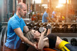 Fitness instructor with a girl at a workout in a fitness center