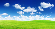 Idyllic View, Green Hills And Blue Sky With White Clouds