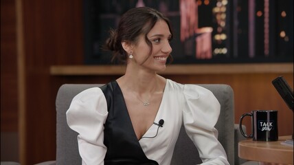 Wall Mural - Portrait of late-night talk show female guest sits on a chair, telling funny story to a host. TV broadcast style show