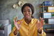 © deagreez - Photo of young afro american brown haired woman speak internet conference make ok sign indoors in office workplace