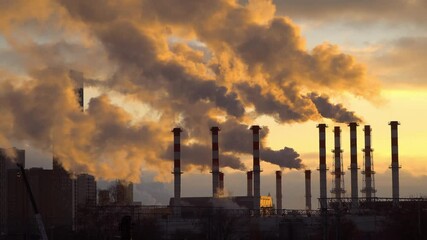 Wall Mural - industrial landscape, the pipes of the thermal power plant at sunset