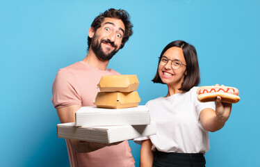 Wall Mural - young couple having take away fast food to home.