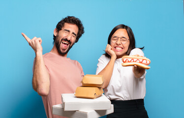 Wall Mural - young couple having take away fast food to home.