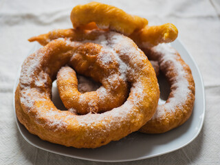 Woman frying vegan cattas sweet fritters, Sardinian Carnival cakes