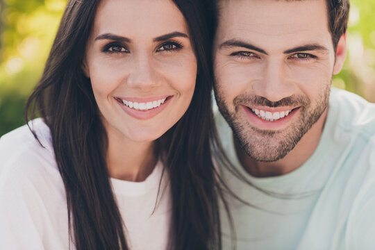 Photo of two positive people romantic couple cuddle shiny white smile wear casual clothes in garden park outside