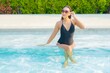 © siraphol - Portrait beautiful young asian woman relax smile enjoy leisure around swimming pool