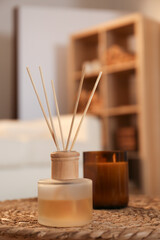 Poster - Aromatic reed air freshener and candle on wicker tray in room