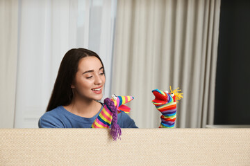 Canvas Print - Young woman performing puppet show at home