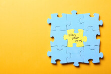 Jigsaw puzzle with phrase Play Your Part on yellow background, top view. Social responsibility concept