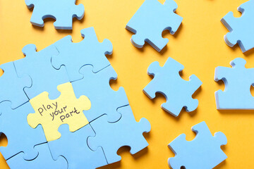 jigsaw puzzle with phrase play your part on yellow background, flat lay. social responsibility conce
