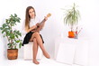 © Enrique Micaelo  - Young woman with guitar on white background with copy space