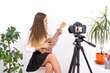 © Enrique Micaelo  - Young woman with guitar creating online content on white background with copy space