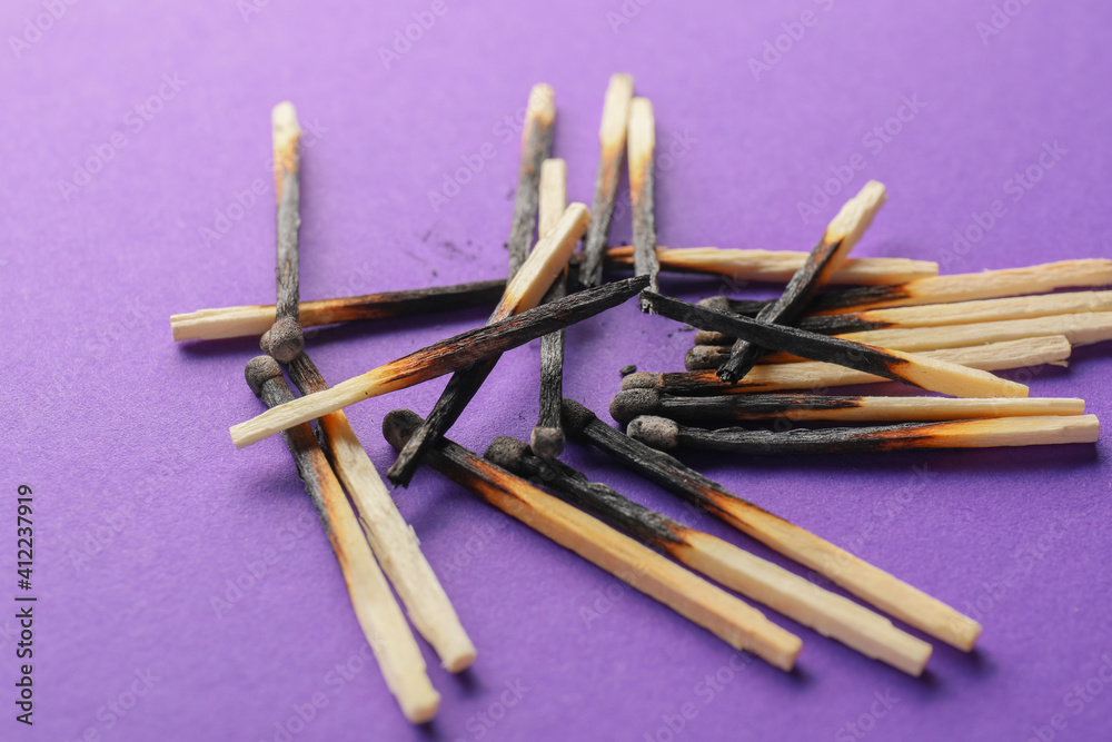 Burnt out matches on color background