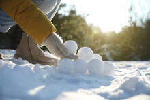 Woman Rolling Snowballs Outdoors On Winter Day, Closeup