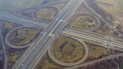 Wall Mural - Highway intersection aerial drone footage with rainy particles in the air