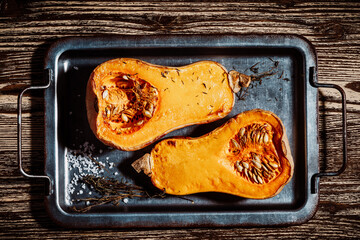 Wall Mural - Roasted pumpkins with thyme herbs on baking sheet