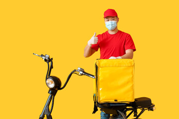 Courier of food delivery service showing thumb-up on color background