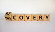 Recovery or discovery symbol. Turned a wooden cube, changed a word 'discovery' to 'recovery'. Beautiful white background. Business and discovery or recovery concept. Copy space.