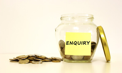 Glass jar with coins for savings. The inscription on the note paper.