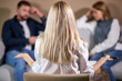 © Roman - rear view on blond young psychologist woman looking at quarrelled couple sitting opposite. focus on head of female therapist during therapy session