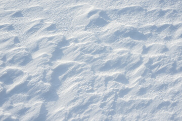 Fresh clean white snow background texture. Winter background with frozen snowflakes and snow mounds. Snow lumps. Seasonal landscape details. Cold weather.